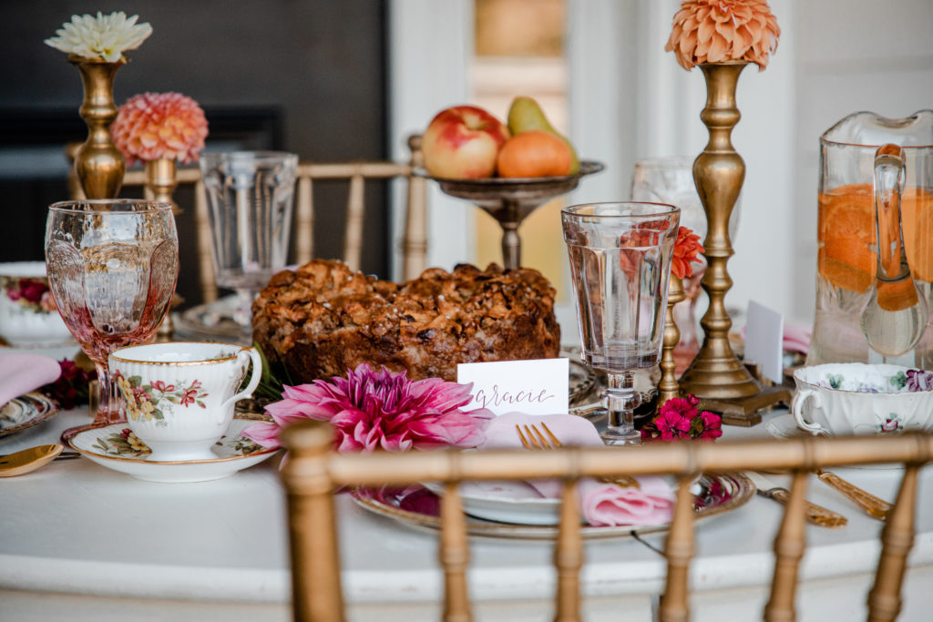 a party table with pretty place settings and a delicious-looking apple streudel